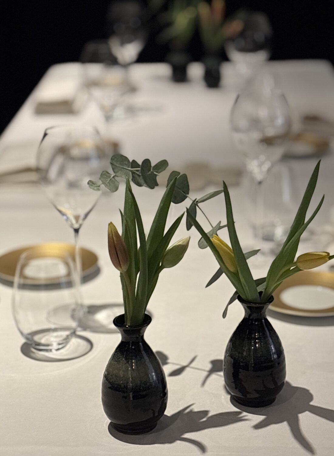 Studio Nian, a set table with vases